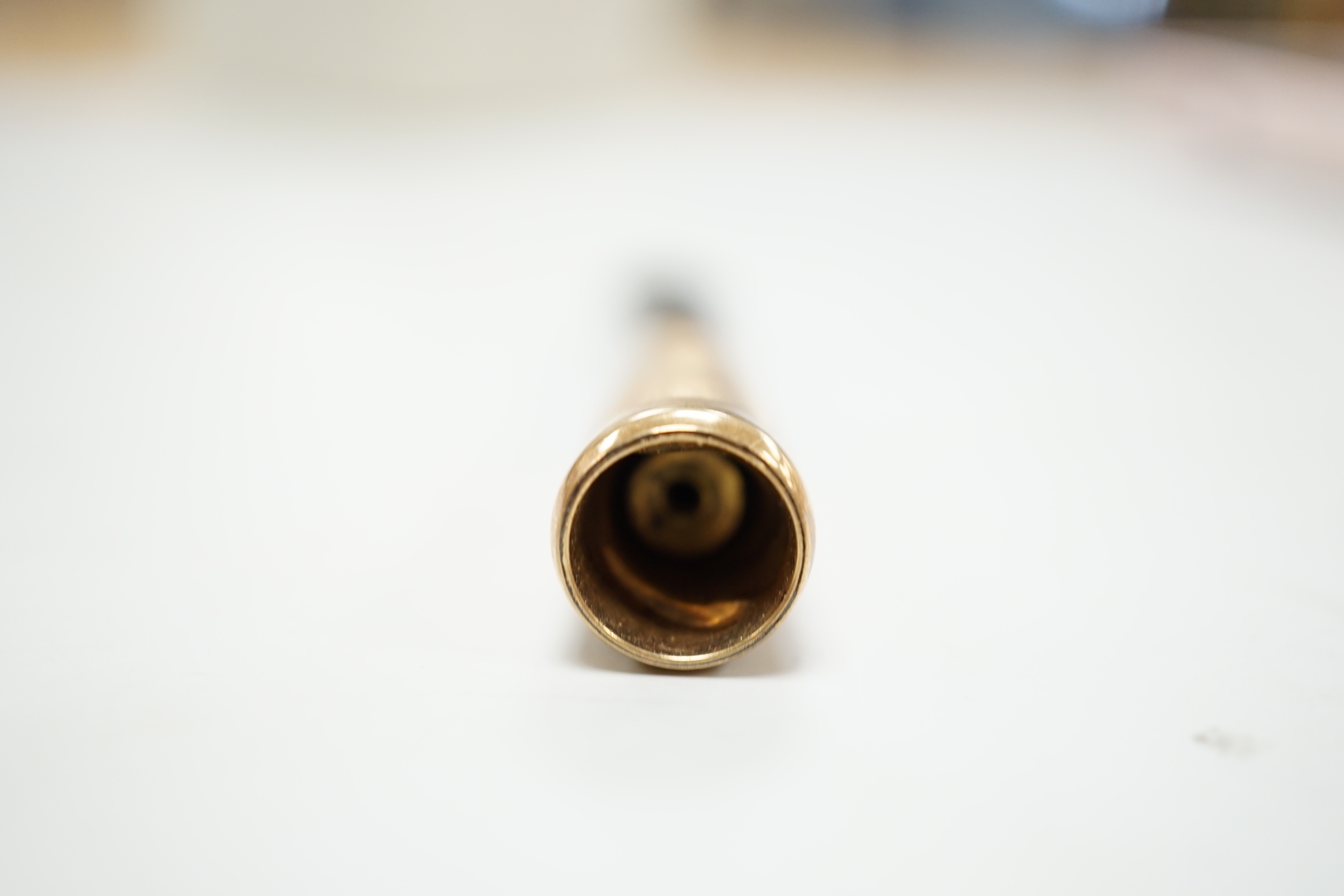 A 1960's 9ct gold mounted cigarette holder, 72mm, housed in Cartier box.